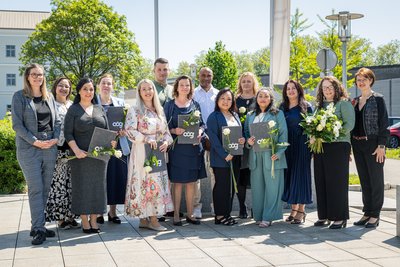 Die PA-AbsolventInnen der Schule für Gesundheits- und Krankenpflege am Kepler Universitätsklinikum mit ihren GratulantInnen im Garten für ein Gruppenfoto.