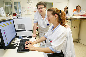 Krankenpflegerinnen vor einem Bildschirm
